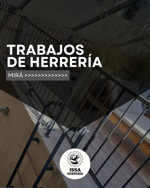 Baranda metálica de una escalera, con el título «Trabajos de herrería»